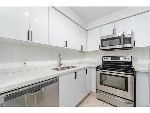 304-4879 Kimbermount Avenue, Mississauga, ON - Indoor Photo Showing Kitchen With Stainless Steel Kitchen With Double Sink