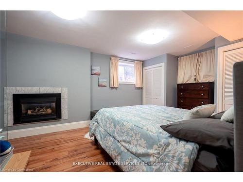 795744 Grey Road 19, The Blue Mountains, ON - Indoor Photo Showing Bedroom With Fireplace