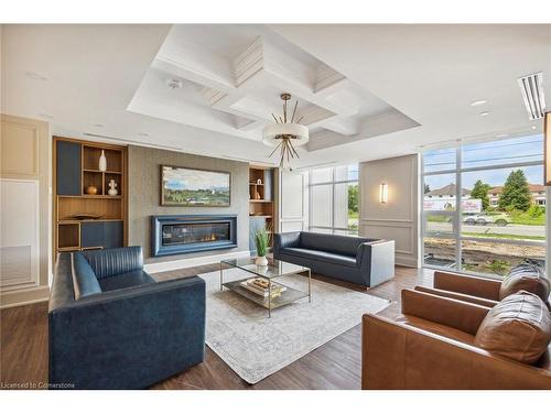 806-450 Dundas Street East, Waterdown, ON - Indoor Photo Showing Living Room With Fireplace