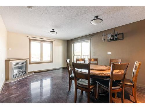 419-8535 Clearwater Drive Ne, Fort Mcmurray, AB - Indoor Photo Showing Dining Room With Fireplace