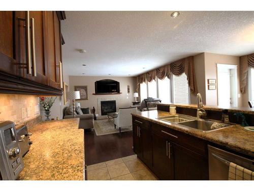 108 Grebe Road, Fort Mcmurray, AB - Indoor Photo Showing Kitchen With Fireplace With Double Sink