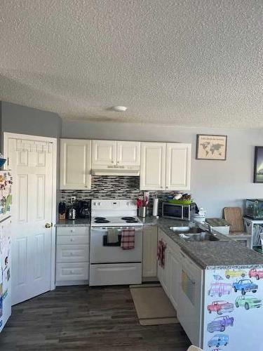 271,275,279,283,287 Mustang Road, Fort Mcmurray, AB - Indoor Photo Showing Kitchen With Double Sink
