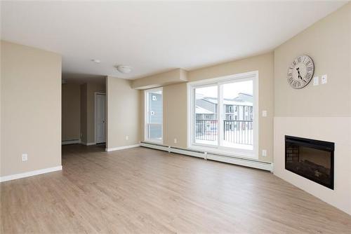 332-201 Abasand Drive, Fort Mcmurray, AB - Indoor Photo Showing Living Room With Fireplace