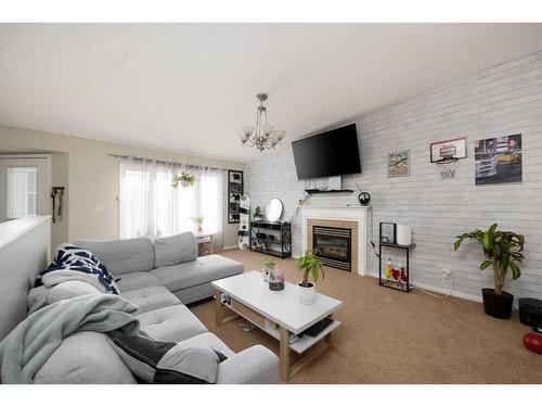 197 Crown Creek, Fort Mcmurray, AB - Indoor Photo Showing Living Room With Fireplace