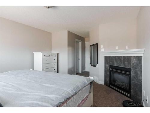 410 Grosbeak Way, Fort Mcmurray, AB - Indoor Photo Showing Bedroom With Fireplace