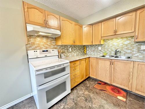 9104A 94 Ave., Lac La Biche, AB - Indoor Photo Showing Kitchen With Double Sink