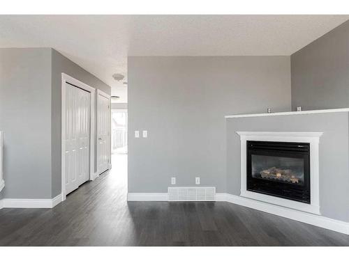 393 Diefenbaker Drive, Fort Mcmurray, AB - Indoor Photo Showing Living Room With Fireplace