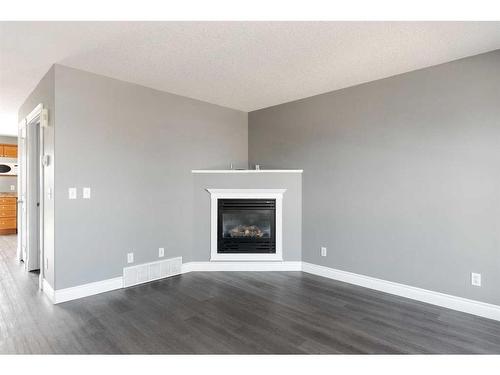 393 Diefenbaker Drive, Fort Mcmurray, AB - Indoor Photo Showing Living Room With Fireplace