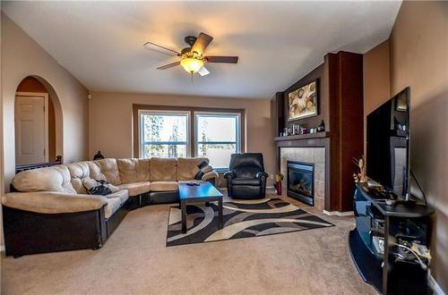 122 Woodward Crescent, Anzac, AB - Indoor Photo Showing Living Room With Fireplace