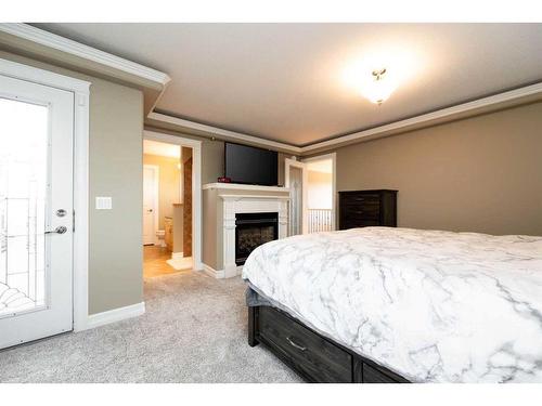 143 Laffont Way, Fort Mcmurray, AB - Indoor Photo Showing Bedroom With Fireplace