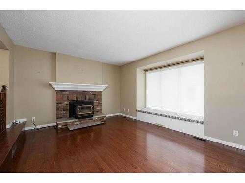 102 Silver Springs Drive, Fort Mcmurray, AB - Indoor Photo Showing Living Room With Fireplace