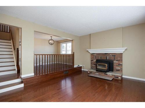 102 Silver Springs Drive, Fort Mcmurray, AB - Indoor Photo Showing Living Room With Fireplace