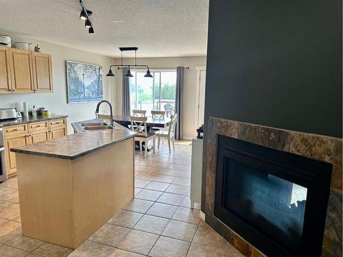 9221 91 Avenue, Lac La Biche, AB - Indoor Photo Showing Kitchen With Fireplace With Double Sink