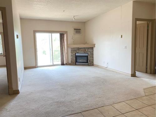 213-9918 Gordon Avenue, Fort Mcmurray, AB - Indoor Photo Showing Living Room With Fireplace