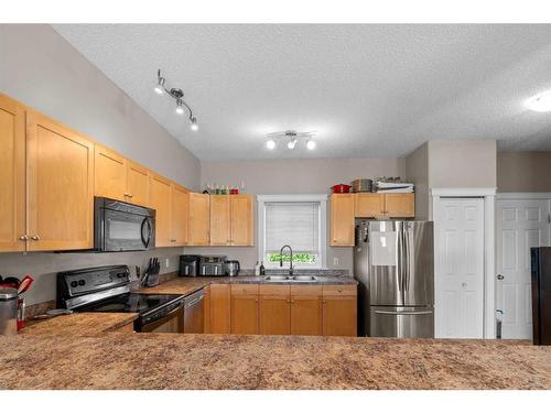 56-313 Millennium Drive, Fort Mcmurray, AB - Indoor Photo Showing Kitchen With Double Sink