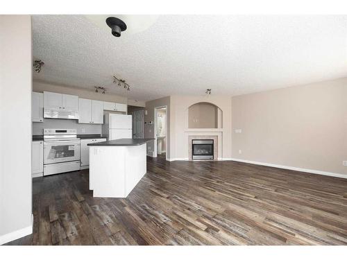 231 Bear Paw Drive, Fort Mcmurray, AB - Indoor Photo Showing Kitchen With Fireplace