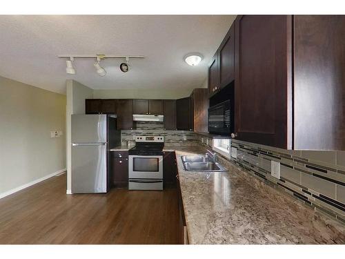 100 Sirius Avenue, Fort Mcmurray, AB - Indoor Photo Showing Kitchen With Double Sink