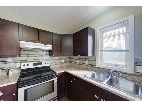 100 Sirius Avenue, Fort Mcmurray, AB - Indoor Photo Showing Kitchen With Double Sink