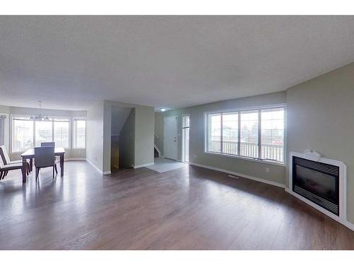 100 Sirius Avenue, Fort Mcmurray, AB - Indoor Photo Showing Living Room With Fireplace