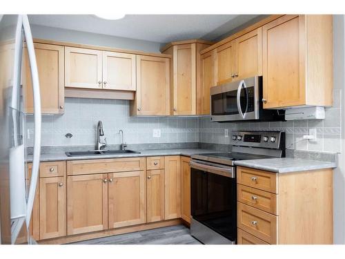 144 O'Coffey Crescent, Fort Mcmurray, AB - Indoor Photo Showing Kitchen With Double Sink