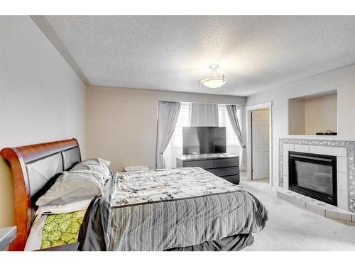 193 Archibald Close, Fort Mcmurray, AB - Indoor Photo Showing Bedroom With Fireplace