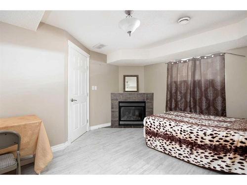 222 Carteret Drive, Fort Mcmurray, AB - Indoor Photo Showing Bedroom With Fireplace