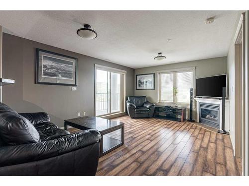 705-8535 Clearwater Drive, Fort Mcmurray, AB - Indoor Photo Showing Living Room With Fireplace