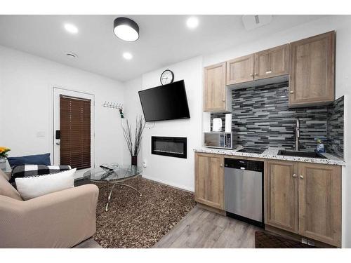 121 Sandstone Lane, Fort Mcmurray, AB - Indoor Photo Showing Kitchen With Fireplace