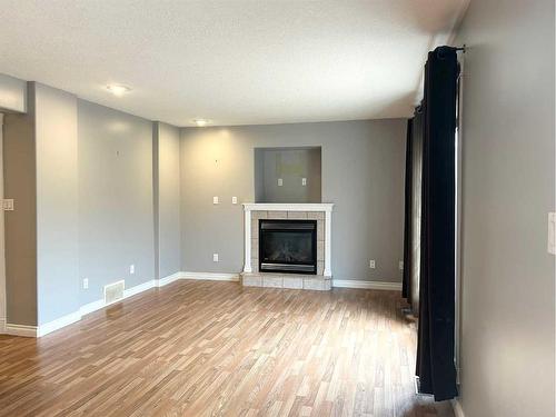 129 O'Coffey Crescent, Fort Mcmurray, AB - Indoor Photo Showing Living Room With Fireplace