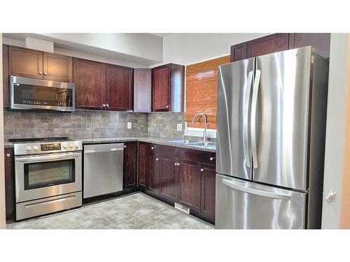 8-313 Millennium Drive, Fort Mcmurray, AB - Indoor Photo Showing Kitchen With Stainless Steel Kitchen With Double Sink