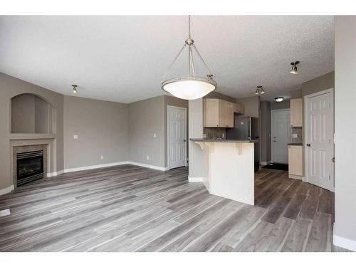 164 Cinnamon Street, Fort Mcmurray, AB - Indoor Photo Showing Kitchen With Fireplace