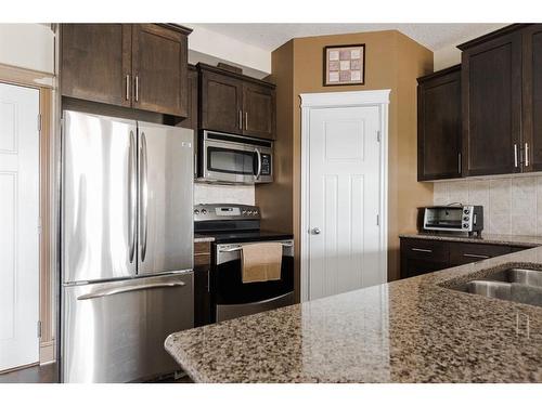 303-9919 Gordon Avenue, Fort Mcmurray, AB - Indoor Photo Showing Kitchen With Stainless Steel Kitchen With Double Sink With Upgraded Kitchen