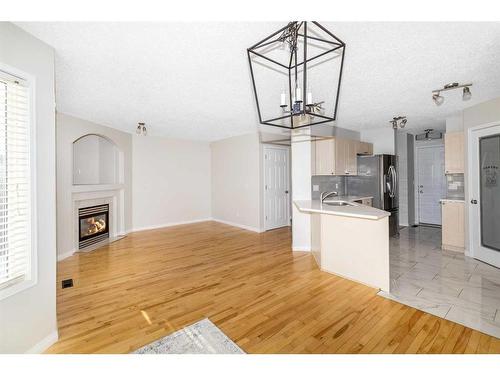 129 Cinnamon Street, Fort Mcmurray, AB - Indoor Photo Showing Kitchen With Fireplace