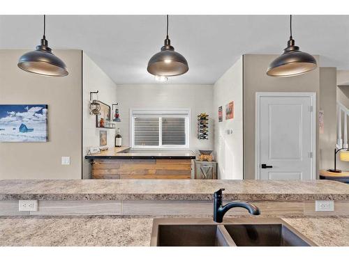 54 Mackenzie Way, Carstairs, AB - Indoor Photo Showing Kitchen With Double Sink