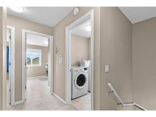 54 Mackenzie Way, Carstairs, AB - Indoor Photo Showing Laundry Room