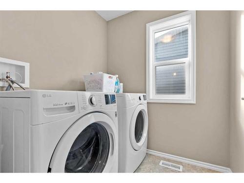 54 Mackenzie Way, Carstairs, AB - Indoor Photo Showing Laundry Room