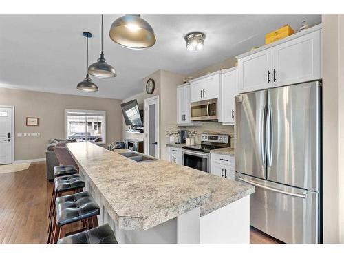 54 Mackenzie Way, Carstairs, AB - Indoor Photo Showing Kitchen With Stainless Steel Kitchen With Double Sink With Upgraded Kitchen