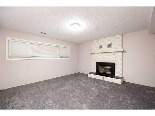 176 Torrie Bay, Fort Mcmurray, AB - Indoor Photo Showing Living Room With Fireplace