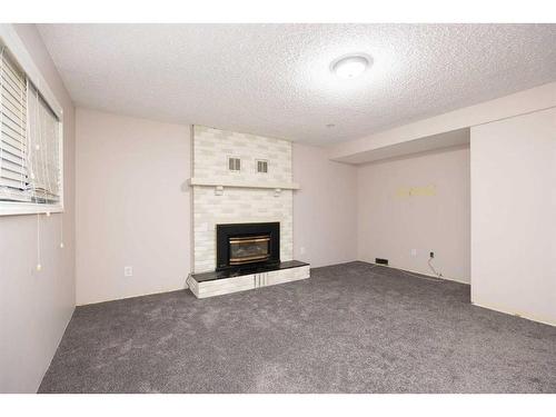 176 Torrie Bay, Fort Mcmurray, AB - Indoor Photo Showing Living Room With Fireplace