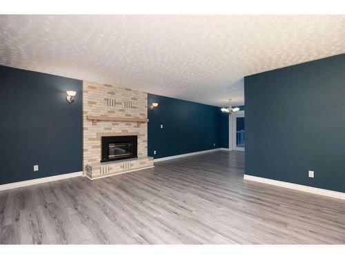 176 Torrie Bay, Fort Mcmurray, AB - Indoor Photo Showing Living Room With Fireplace