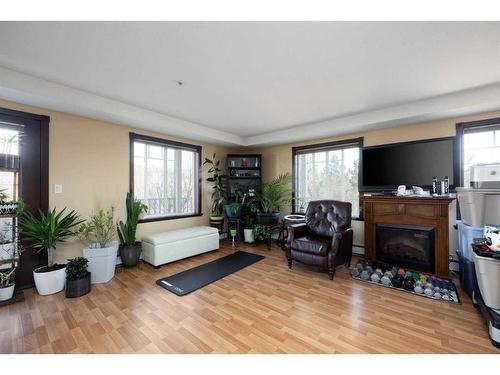 202-10217 Queen Street, Fort Mcmurray, AB - Indoor Photo Showing Living Room With Fireplace