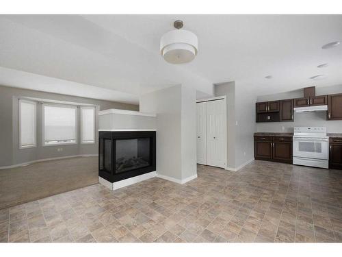 16-120 Warren Way, Fort Mcmurray, AB - Indoor Photo Showing Kitchen With Fireplace