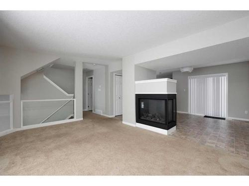 16-120 Warren Way, Fort Mcmurray, AB - Indoor Photo Showing Living Room With Fireplace