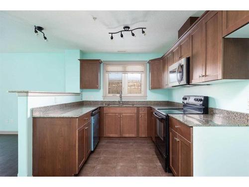 204-8535 Clearwater Drive, Fort Mcmurray, AB - Indoor Photo Showing Kitchen With Double Sink