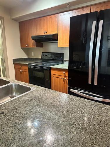 305-10115 Morrison Street, Fort Mcmurray, AB - Indoor Photo Showing Kitchen With Double Sink