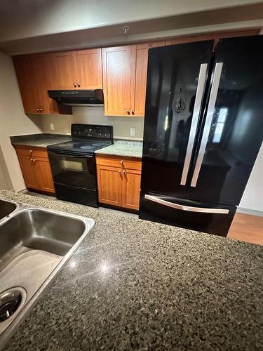 305-10115 Morrison Street, Fort Mcmurray, AB - Indoor Photo Showing Kitchen With Double Sink