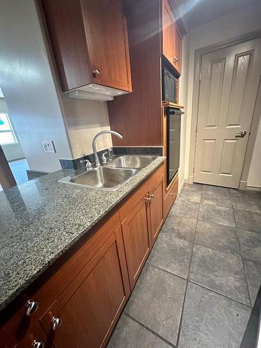 305-10115 Morrison Street, Fort Mcmurray, AB - Indoor Photo Showing Kitchen With Double Sink