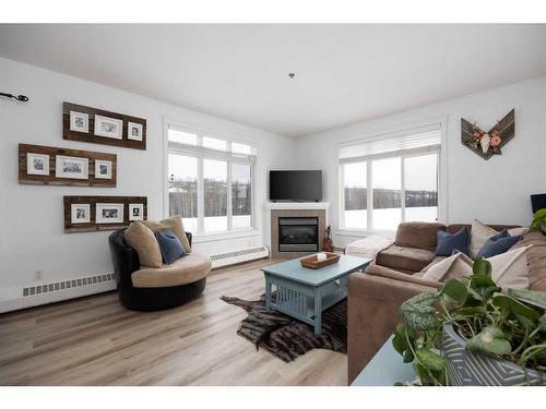 203-100 Denholm Gate, Fort Mcmurray, AB - Indoor Photo Showing Living Room With Fireplace