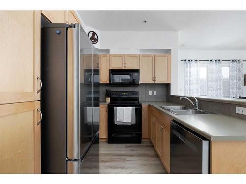 203-100 Denholm Gate, Fort Mcmurray, AB - Indoor Photo Showing Kitchen With Double Sink