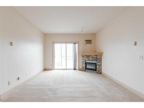 302-9918 Gordon Avenue, Fort Mcmurray, AB - Indoor Photo Showing Living Room With Fireplace